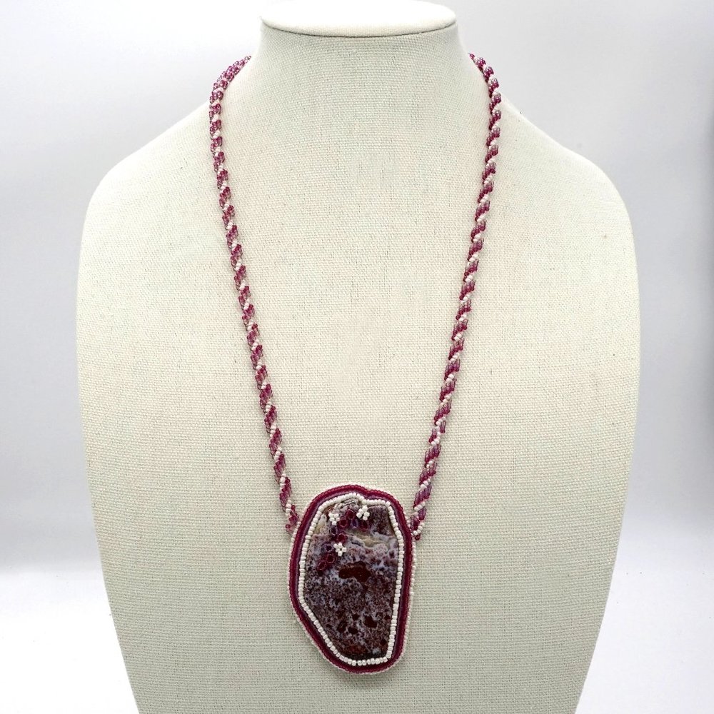 Necklace with seed beads and large stone.